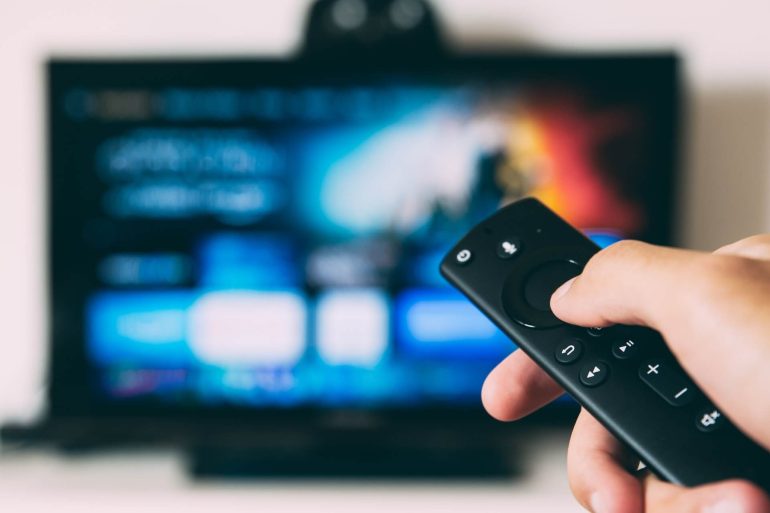 remote held in front of a television