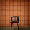 vintage television on a stall with vintage wallpaper background